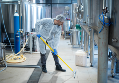 professional-industrial-cleaner-protective-uniform-cleaning-floor-food-processing-plant-1.webp
