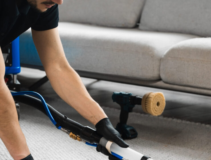 Smearing detergent deep into fibers to clean carpet with drill and brush. Cleaning the carpet at home using drill and brush. Easy removal of stains on carpet with drill and brush