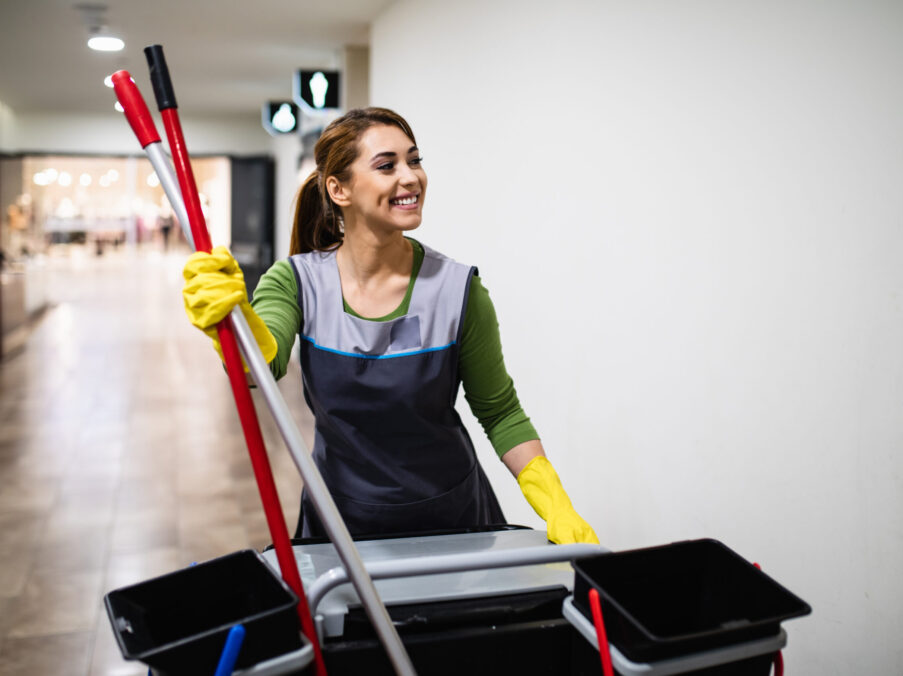 Beautiful young woman cleaning at shopping mall. Cleaning concept.