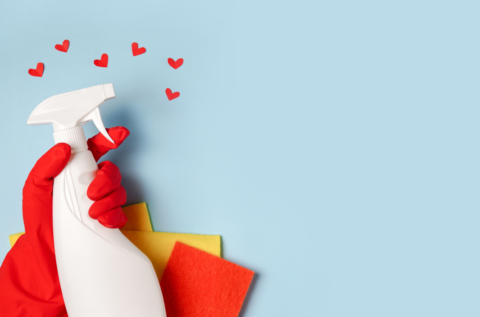 house-cleaning-spray-female-hand-blue-background-with-red-hearts-copy-space.webp