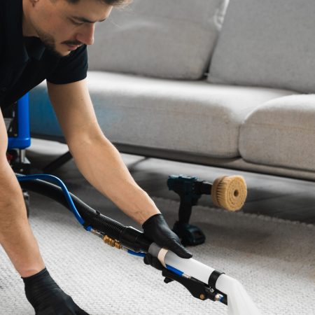 Smearing detergent deep into fibers to clean carpet with drill and brush. Cleaning the carpet at home using drill and brush. Easy removal of stains on carpet with drill and brush